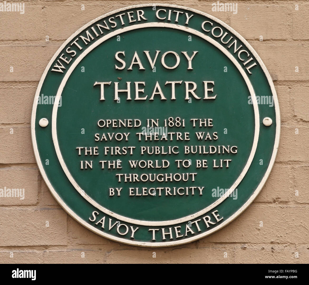 Green plaque at the Savoy Theatre, London which was the first public building in the world to be lit throughout by electricity. Stock Photo