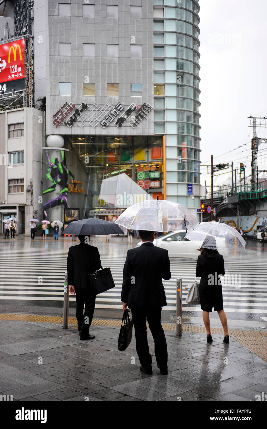 Japanese business men and woman at a cross traffic lighter in Ginza Tokyo Japan Stock Photo