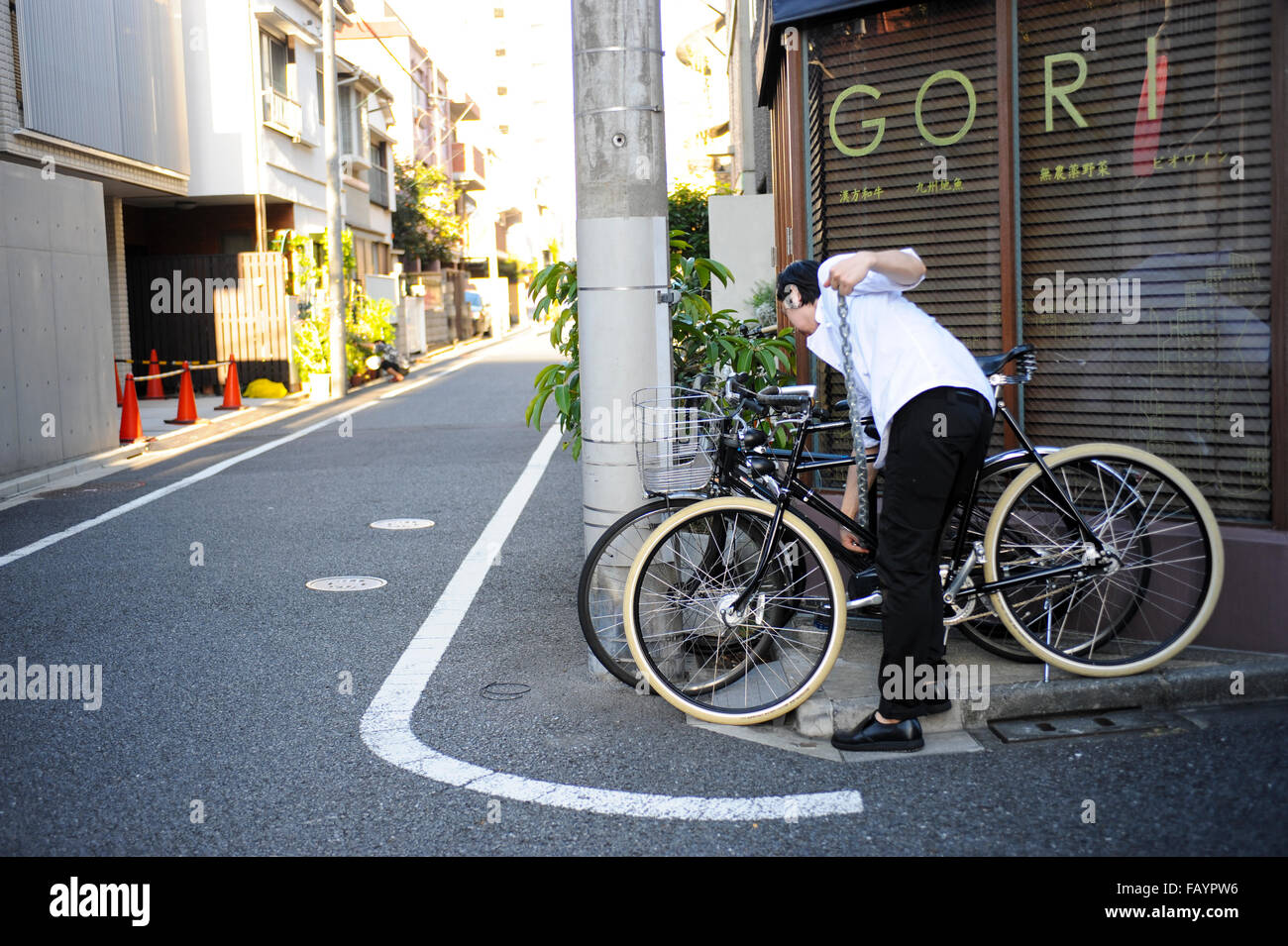 Boy and his bicycle at the entrance of a restaurant in Rappongi Tokyo Japan Stock Photo