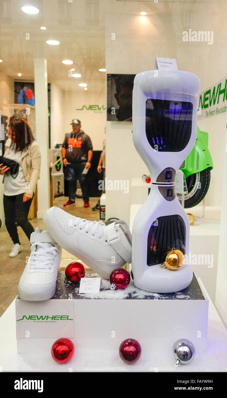 A  hoverboard, self-balancing two-wheeled board, or self-balancing electric scooter on display in window shop. Stock Photo