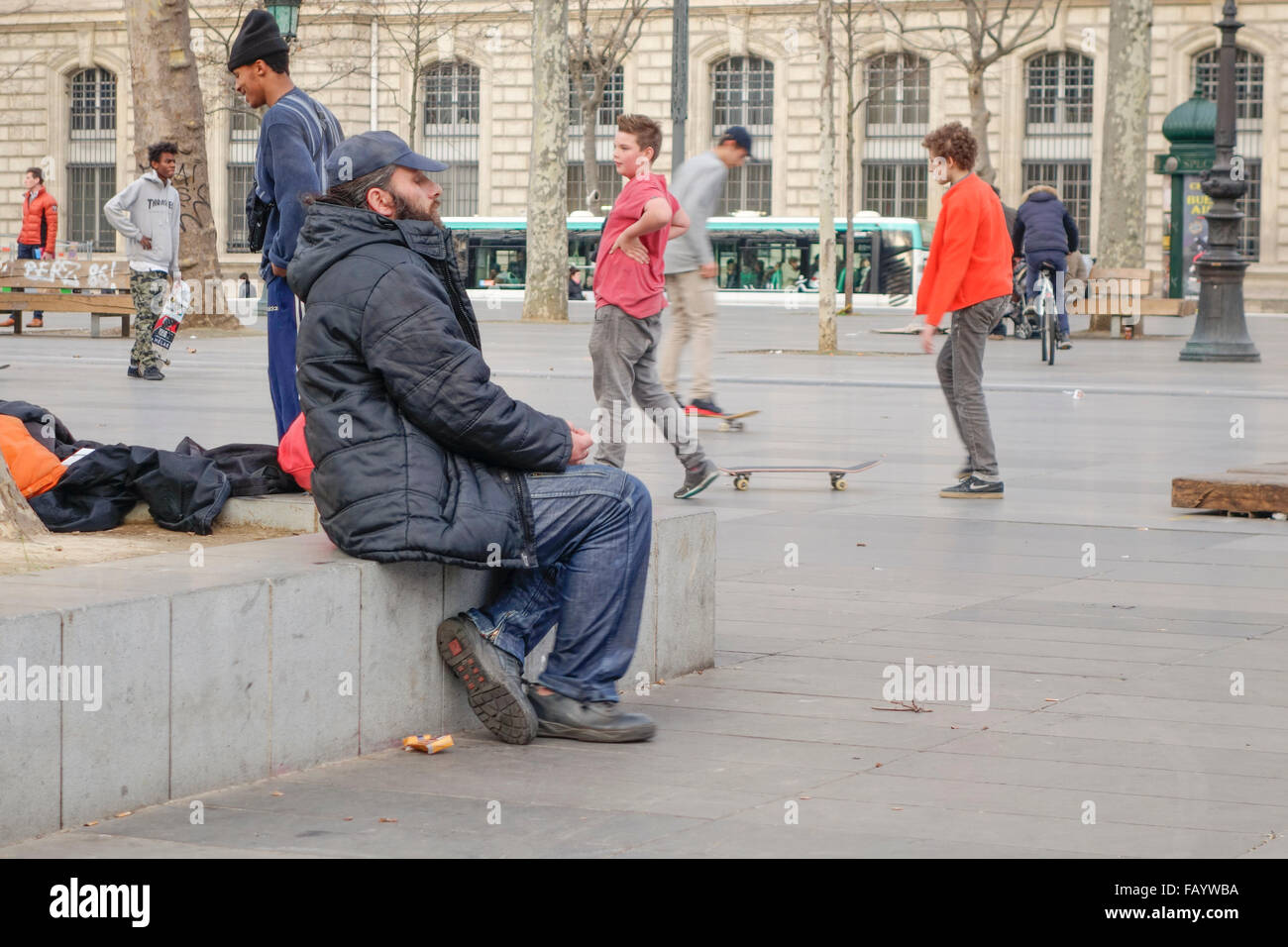 Boys hanging out Skateboarding at Place de la Republique, Man sitting, square, Paris, France. Stock Photo