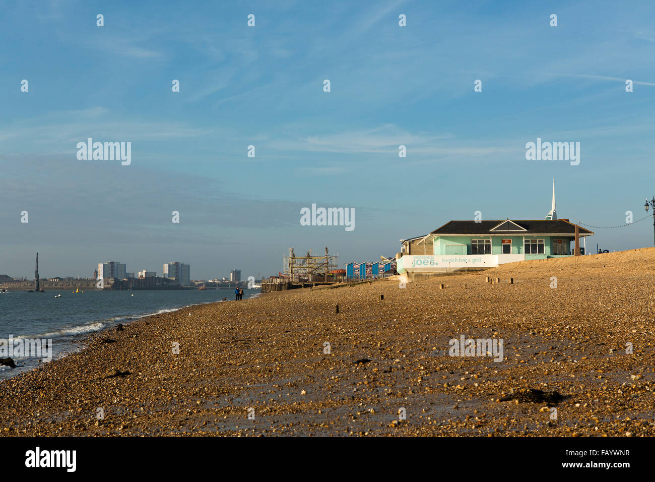 Cafe on a cold windswept day out of season in Southsea. Looking down the beach towards the harbour entrance Stock Photo