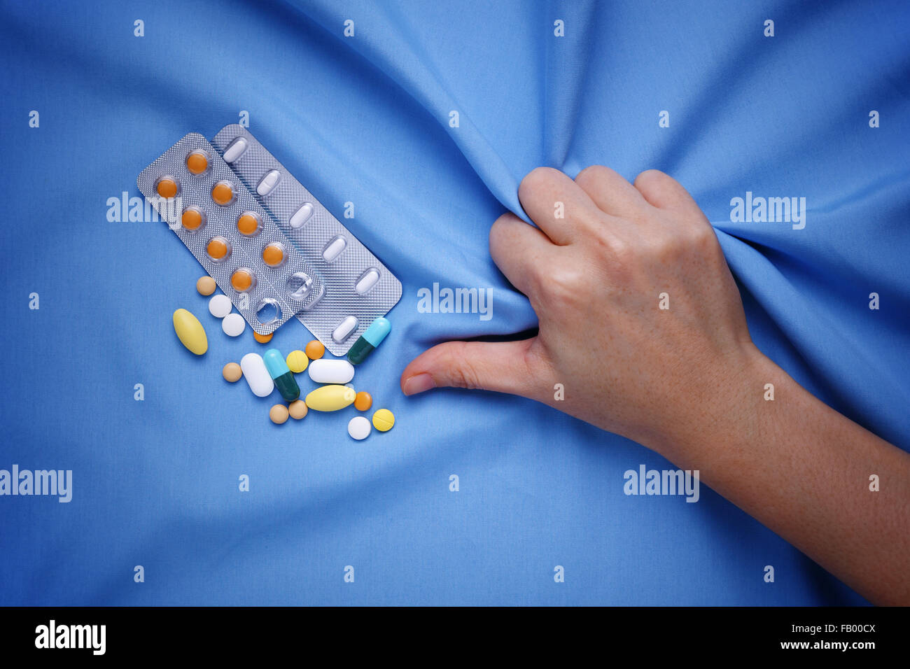 Closeup hand with pain and suffer from illness with medicine pills Stock Photo