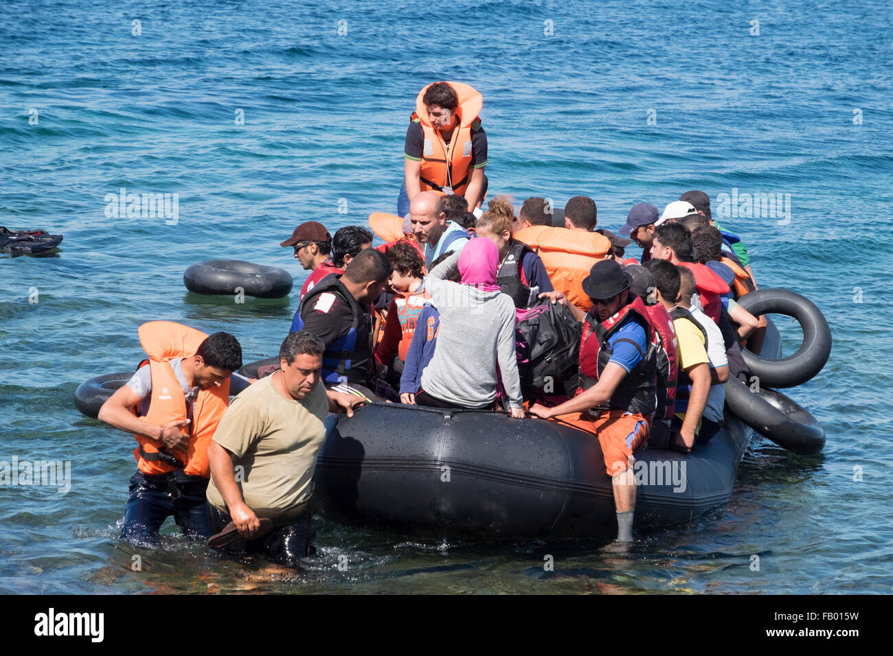 Syrian refugees cross from Turkey in a rubber raft to land on a beach on the Greek island of Lesvos/Lesbos Stock Photo