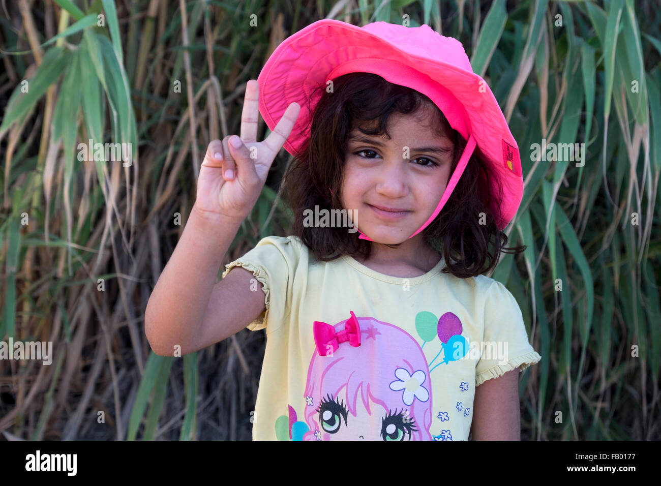 Lovely young refugee girl shortly after crossing from Turkey to Greece in a rubber raft Stock Photo