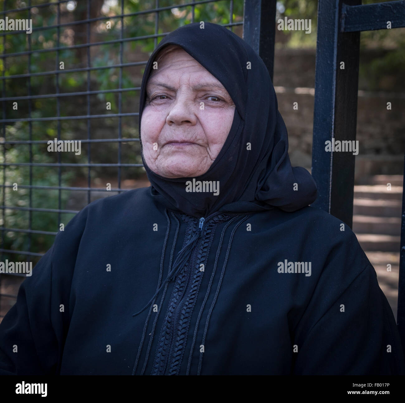 Senior Syrian refugee woman waiting to be processed for asylum in Lesvos after crossing from Turkey in a raft Stock Photo