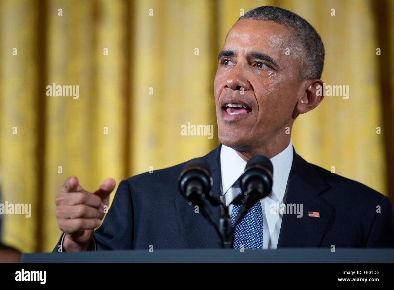 U.S President Barack Obama discuss gun violence as a tear rolls down his cheek during an emotional announcement on gun control in the East Room of the White House January 5, 2016 in Washington, DC. Stock Photo