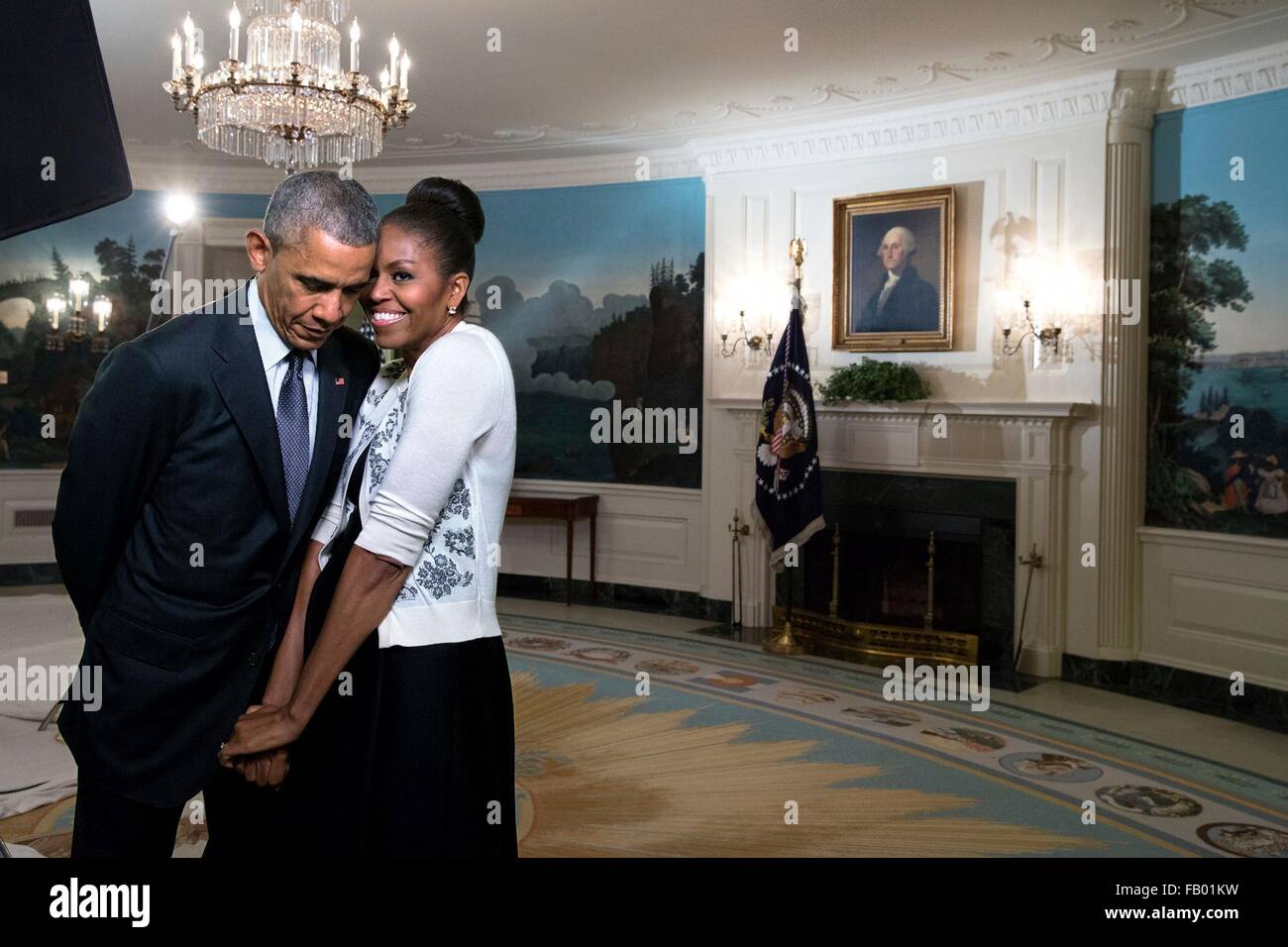 U.S First Lady Michelle Obama snuggles against husband President Barack Obama before a video taping for the 2015 World Expo in the Diplomatic Reception Room of the White House March 27, 2015 in Washington, DC. Stock Photo