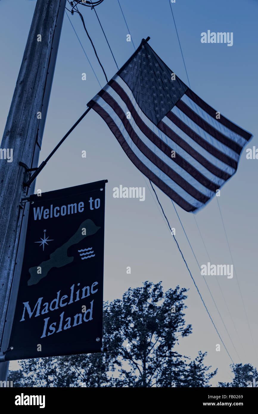 Welcome sign and American flag as you enter the town of Madeline Island (dark colors) Stock Photo