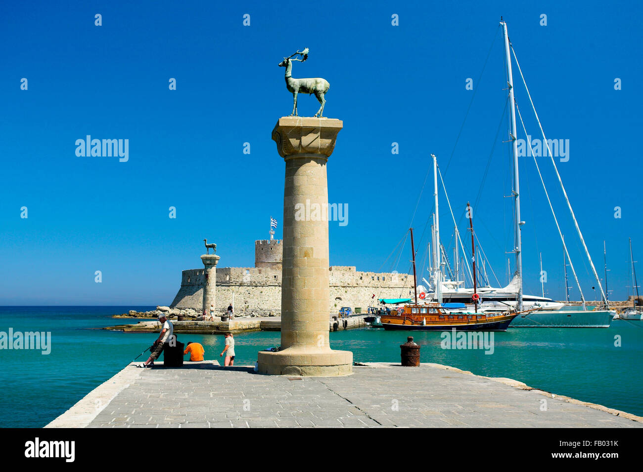 Mandraki harbour and fortress Agios Nicolaos in Rhodes town, Rhodes Island, Greece, UNESCO Stock Photo