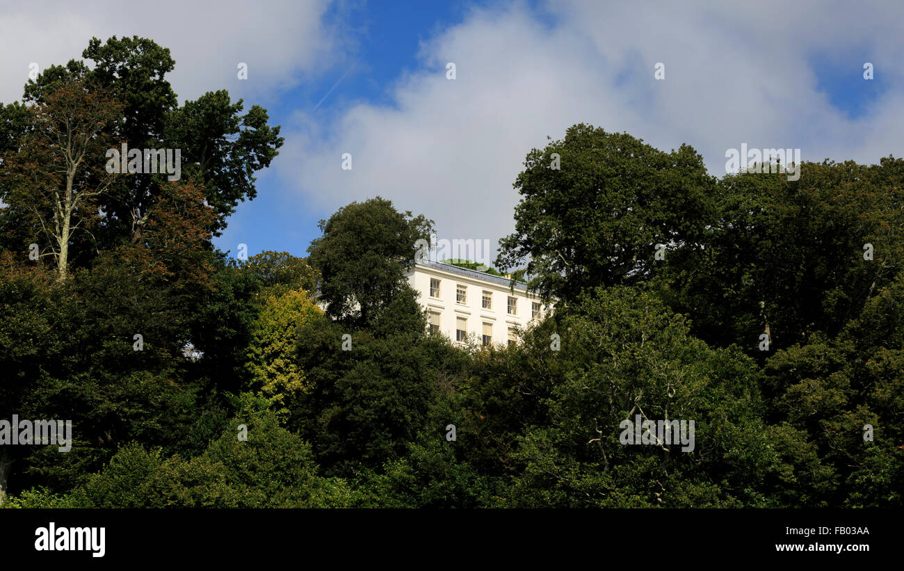 A glimpse of Greenway House, the former home of acclaimed crime writer Agatha Christie, as viewed from River Dart, Devon Stock Photo
