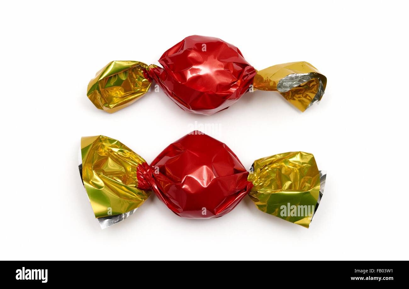 2 sweets wrapped in red and gold wrappers Stock Photo Alamy