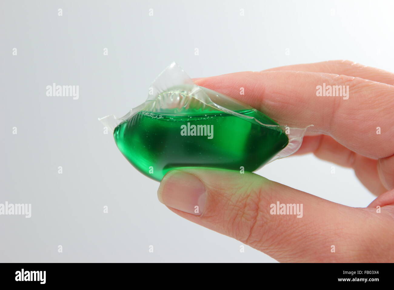 A liquid laundry detergent capsule held by a man, UK Stock Photo Alamy