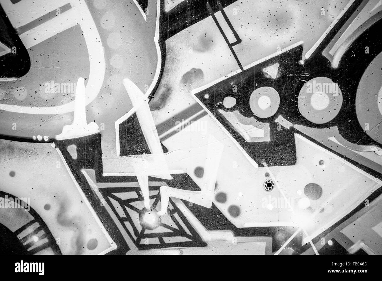 grunge, a city wall with graffiti in black and white, urban art Stock