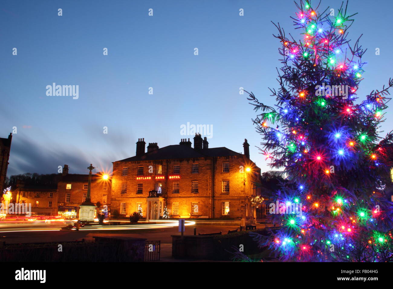 A Christmas tree on display in Bakewell town centre, looking to the Rutland Arms Hotel, Peak District, Derbyshire England UK Stock Photo