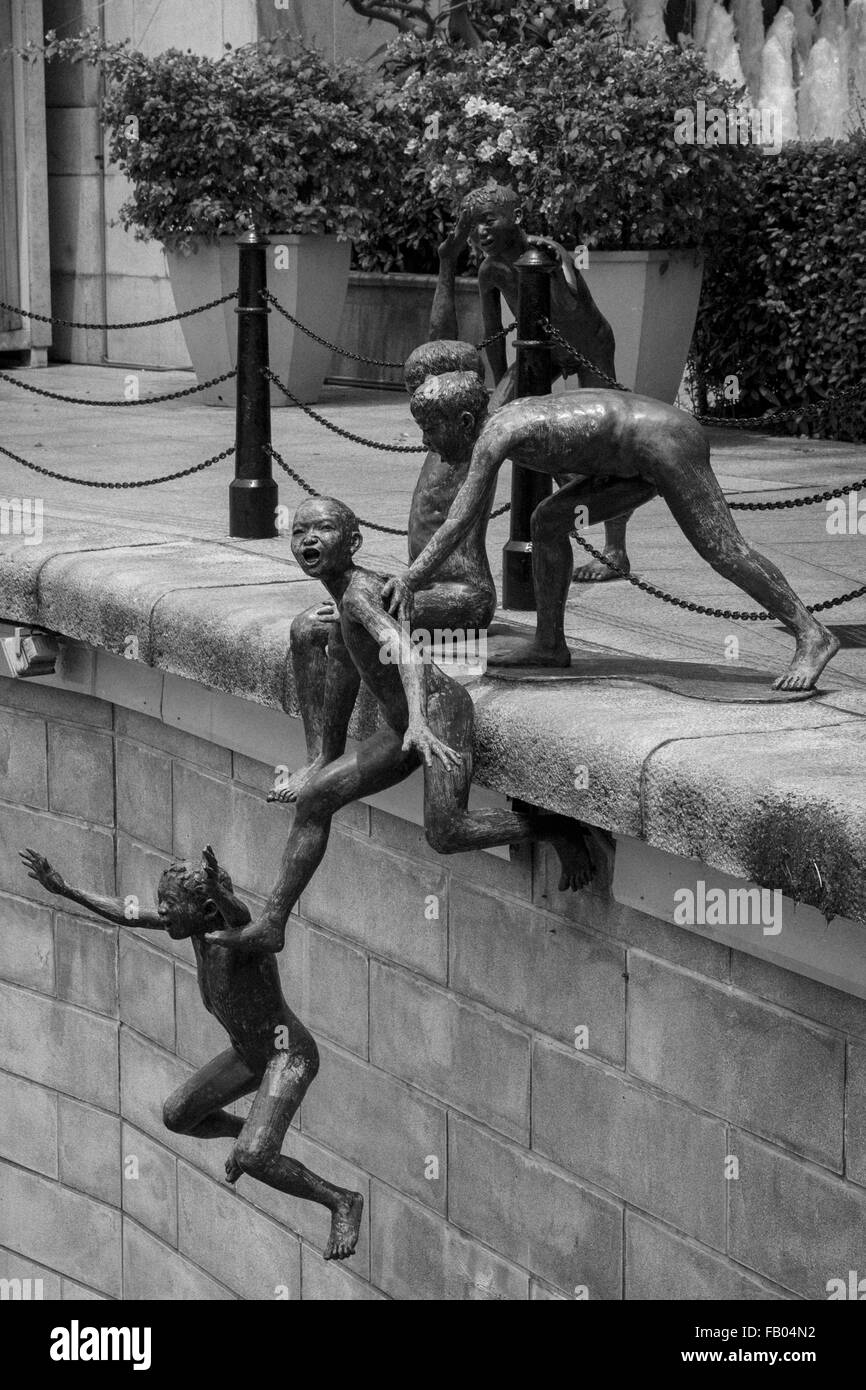 The bronze sculpture 'First Generation', by Chong Fah Cheong, of five young boys leaping into the Singapore River, Singapore Stock Photo