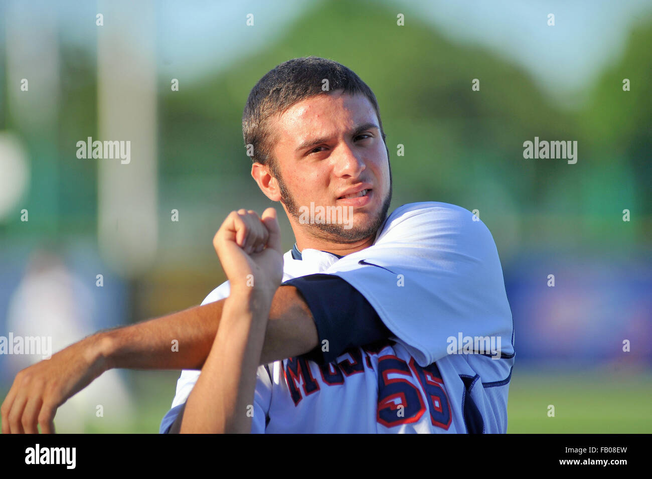 High school player stretching and warming up prior to the start of a state playoff baseball game. USA. Stock Photo