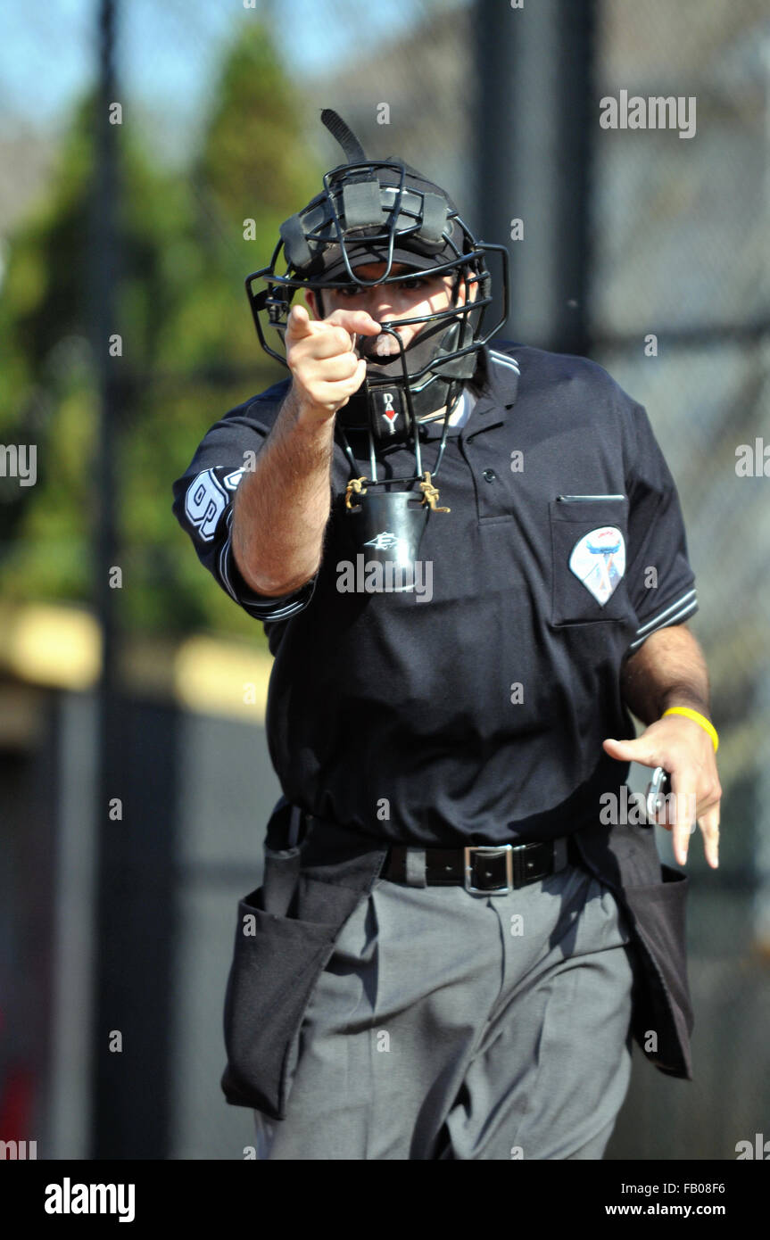 A home plate umpire makes a strike call during a high school baseball game. USA. Stock Photo