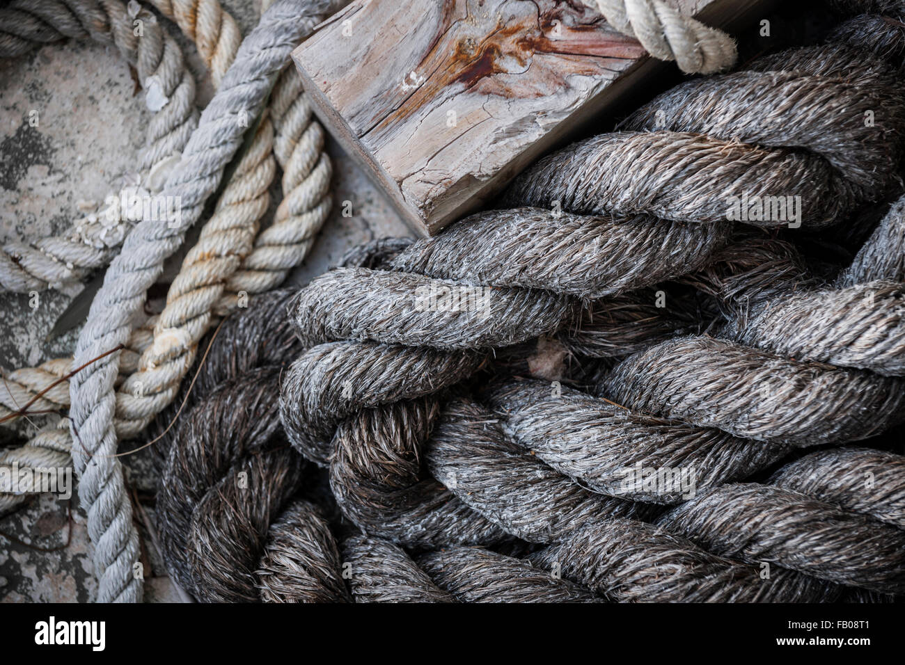 Pile of old weathered nautical ropes on dock, close up.  Key West harbor, Florida. Stock Photo