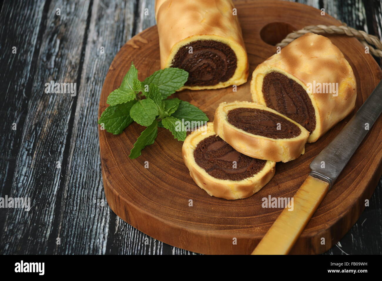 Mini rolled cakes with chocolate flavor inside, layered with vanilla flavor sponge. Stock Photo