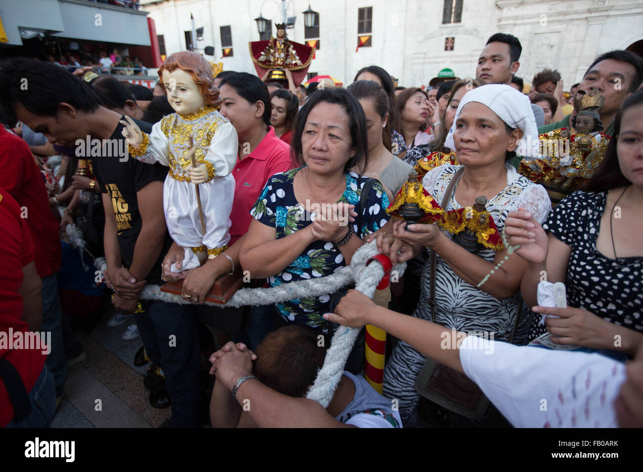 Cebu City, Philippines. 07th Jan, 2016. Following a dawn procession starting at 4:30 am, thousands of Filipino Catholics flock to the oldest Roman Catholic Church in the Philippines - the Basilica Minore del St.Nino in Cebu City. The event marks the official start of the Fiesta Señor - a nine day religious festival honouring the Santo Nino De Cebu (Holy Child of Cebu) Many devotees bring with them a Santo Nino figurine representing the Child Jesus. Credit:  imagegallery2/Alamy Live News Stock Photo