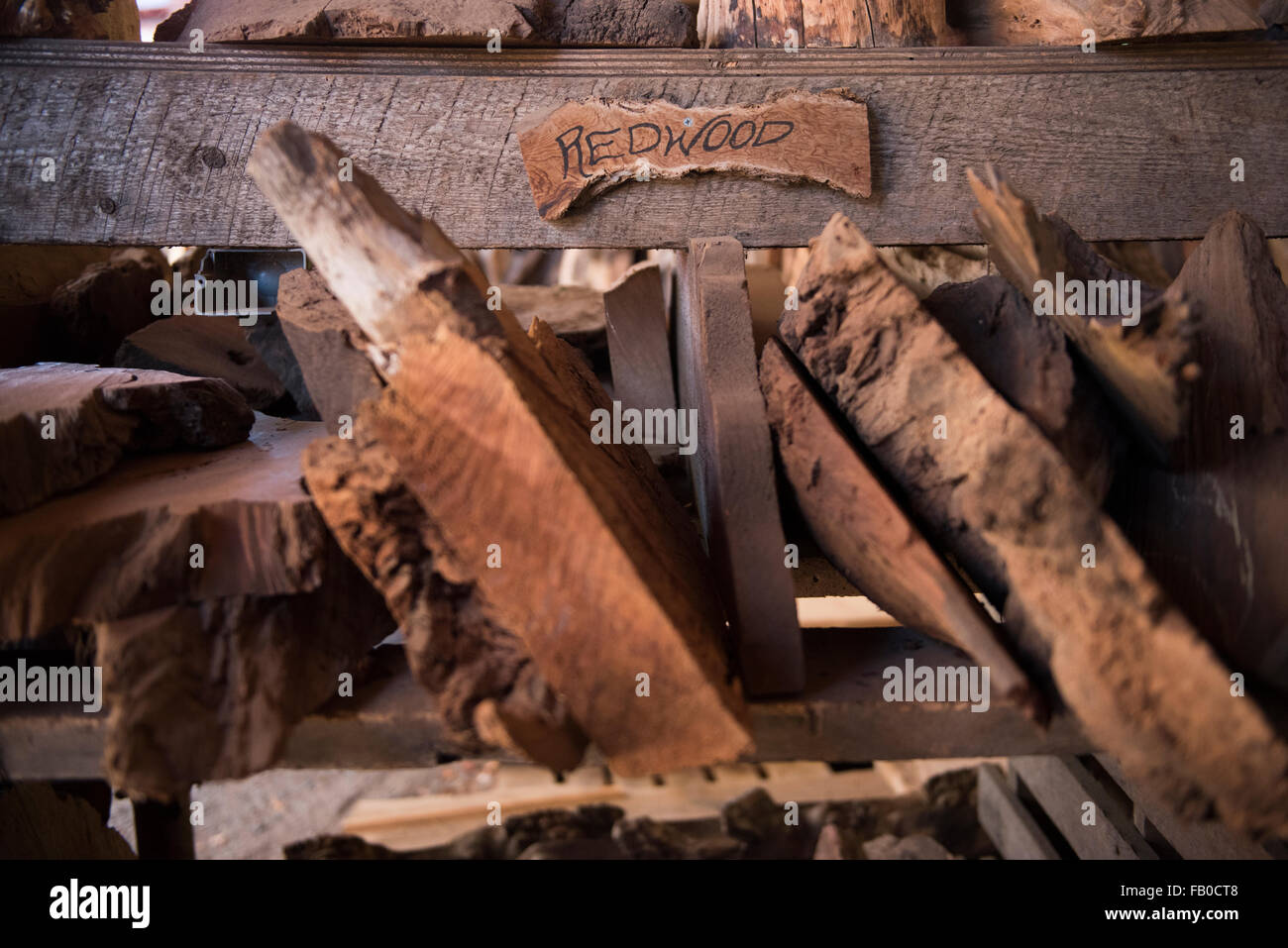 Slabs of redwood wood for sale at It's A Burl Gallery, a gallery, wood yard, and shop in Kerby, Oregon. Stock Photo