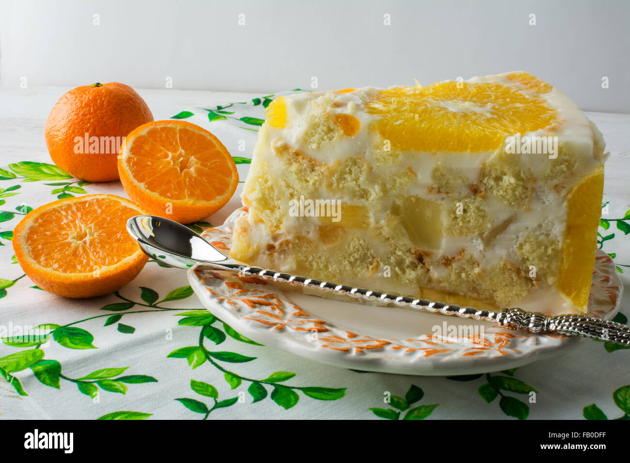 Delicious white jelly fruit tart slice, mousse whipped cream pie yoghurt yogurt souffles cake with orange and tangerine. Homemad Stock Photo