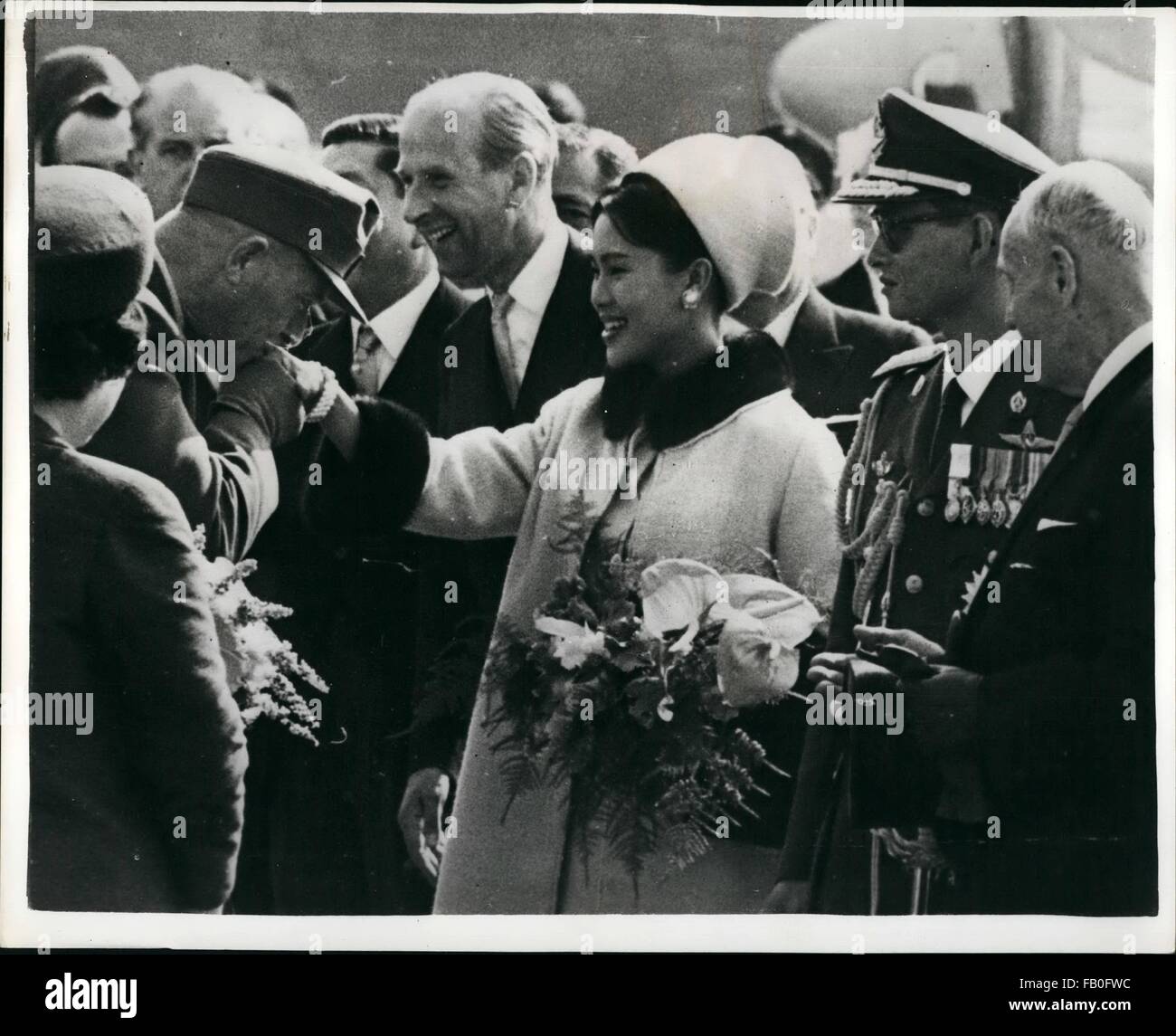 1980 - Beautiful Queen Sirikit Visits Vienna. On Tuesday morning the King and Queen of Thailand, King Bhumibol and his lovely wife Queen Sirikit landed at Vienna airport. They were greeted by the President Dr. Adolf Scharf and the leading men in the Austrian government and taken to the Hotel Imperial where they will be entertained during their stay. They plan to remain there until October 2nd, visiting all the attractions of the Waltz city. OPS: the Austrian President's adjutant Kissing Queen Sirikit's hand and making a small speech of welcome. To her right are King Bhumibol and Dr. Scharf. (C Stock Photo