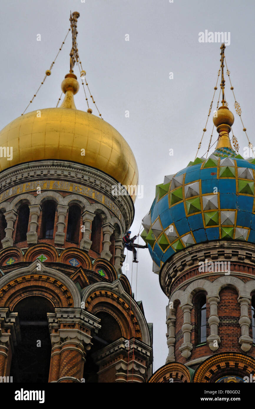 Man on a trapeze between two domes of a church in Moscow Stock Photo