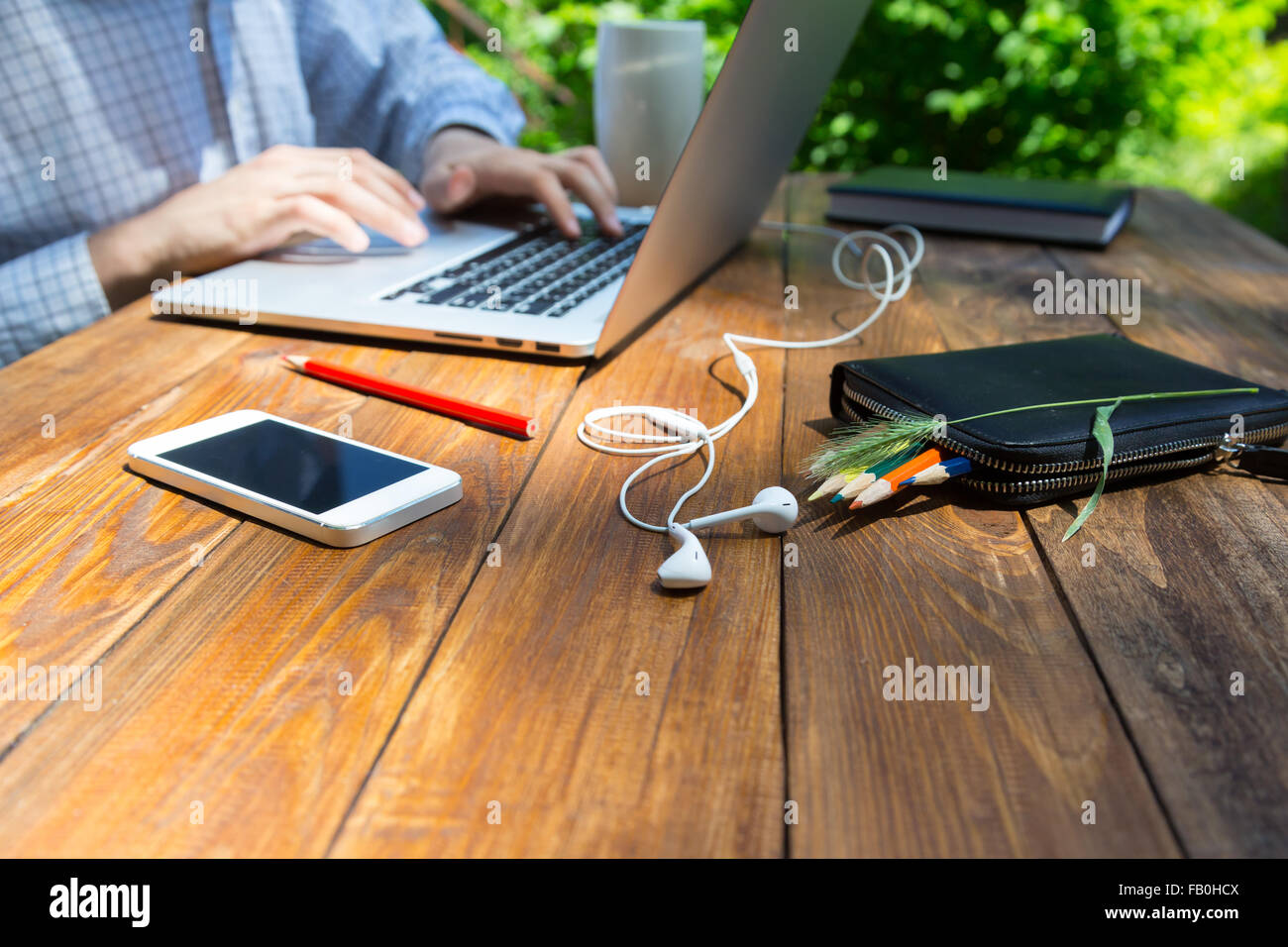 Textured wooden desk and hardworking man Stock Photo