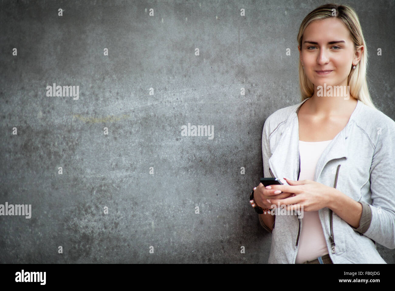 Attractive young woman using smart phone. Stock Photo