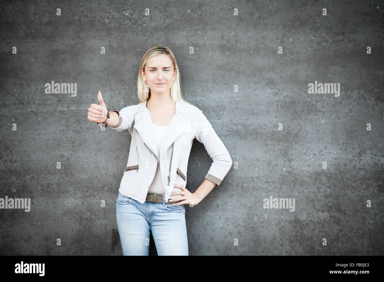Attractive young woman showing thumbs up Stock Photo
