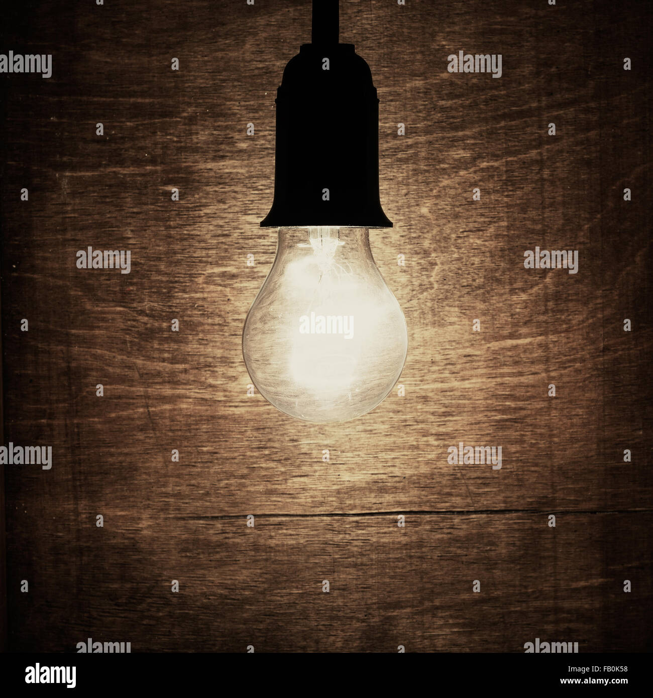 Light bulb against rustic wood background Stock Photo