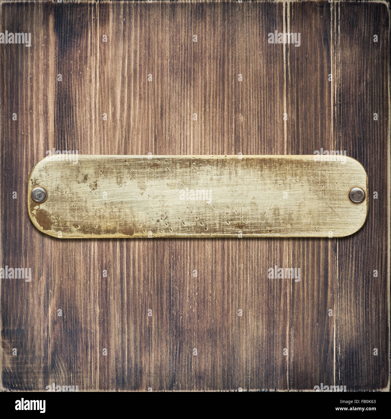 Worn metal label plate nailed to wooden background Stock Photo - Alamy
