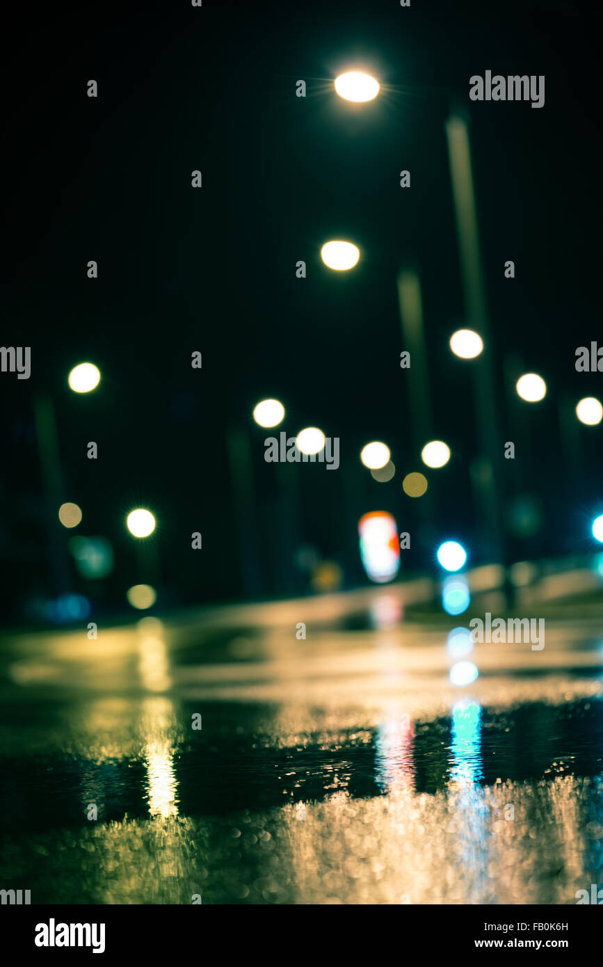 Abstract dark blurry urban background. Wet road Stock Photo - Alamy