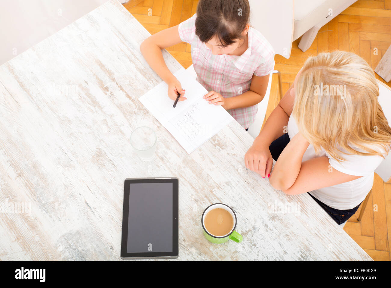 A mother helping her daughter with the homework Stock Photo - Alamy
