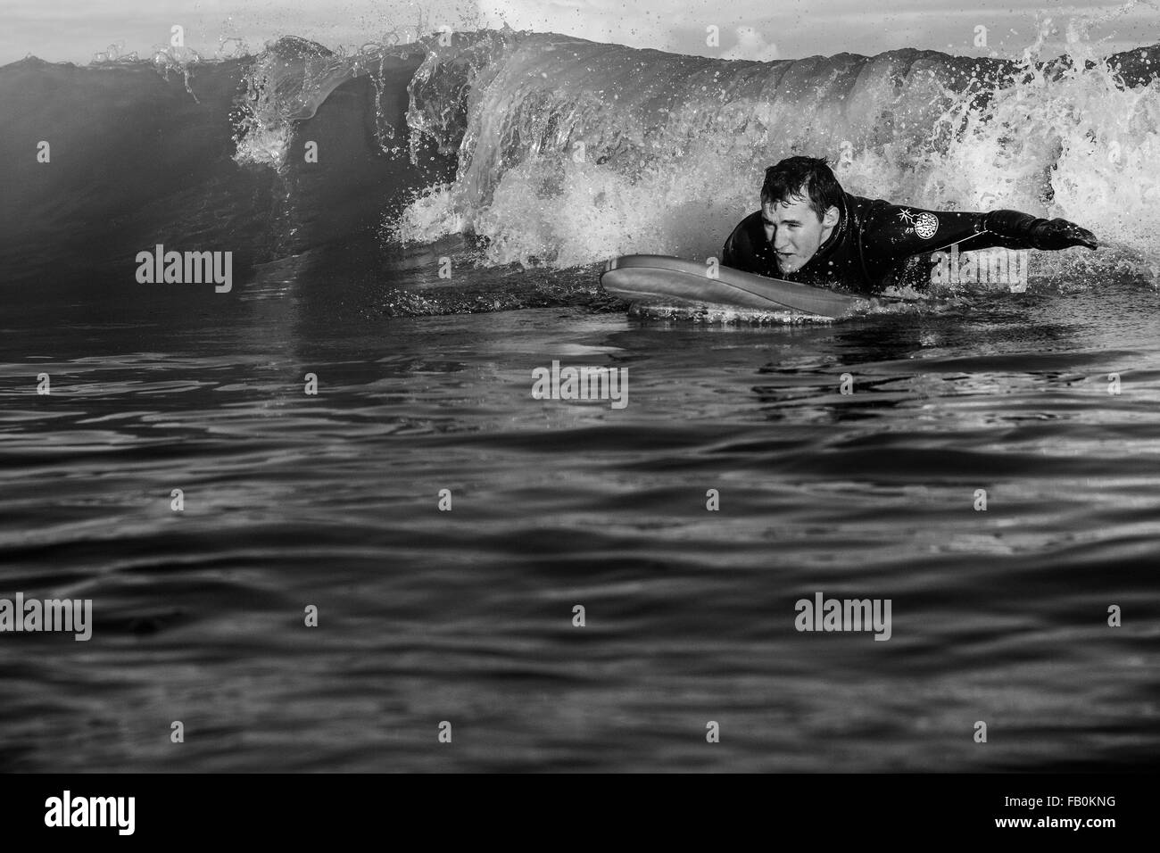 surfers on a wave  in Kent Broadistaris  black and white image  water sea Stock Photo