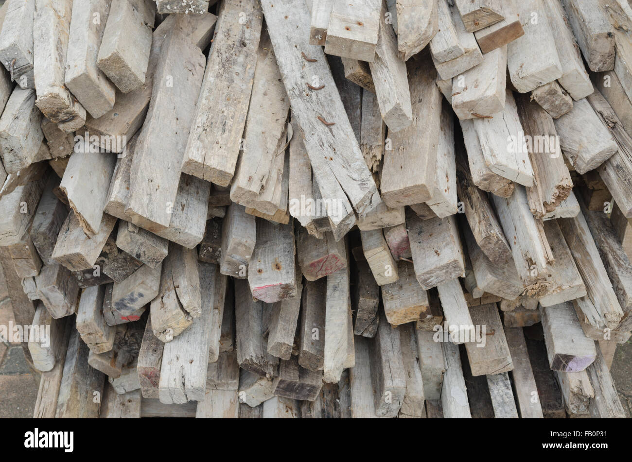 Pile of tree trunks, Lumber pile at construction site wasted wood material for recycling. Stock Photo