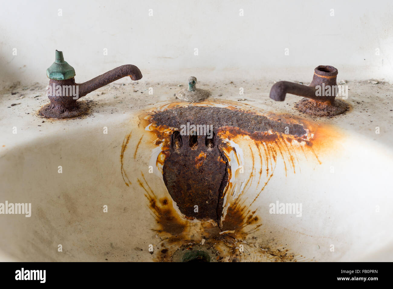 Wall mounted white and rusty steel sink at Alcatraz prison Stock Photo