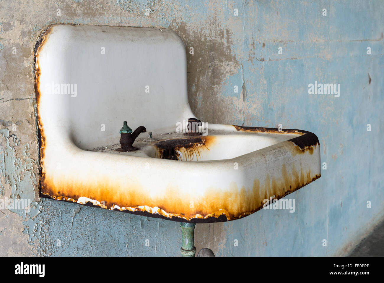 Wall mounted white and rusty steel sink at Alcatraz prison Stock Photo