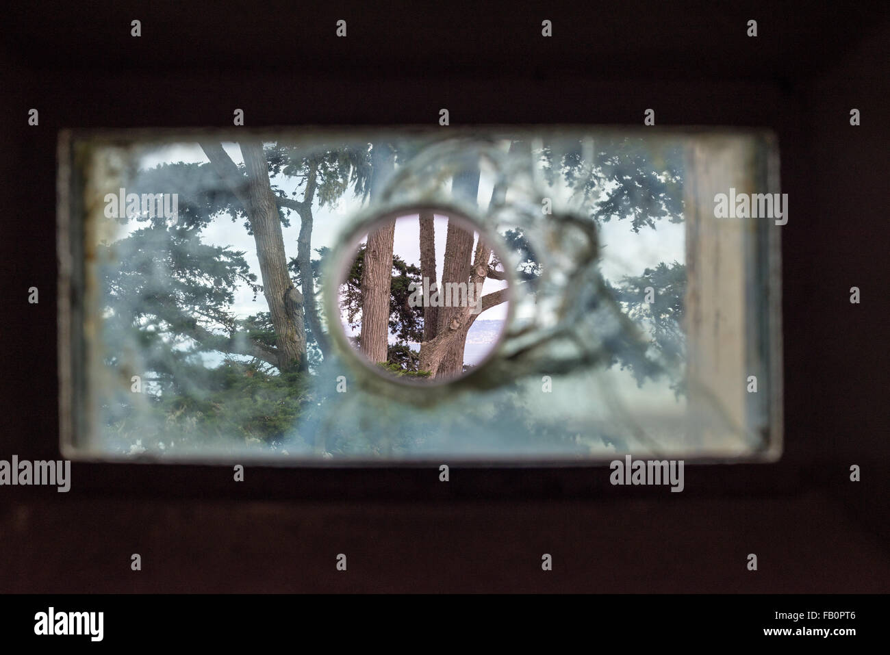 View through bullet-proof window at the prison cell block on Alcatraz island Stock Photo