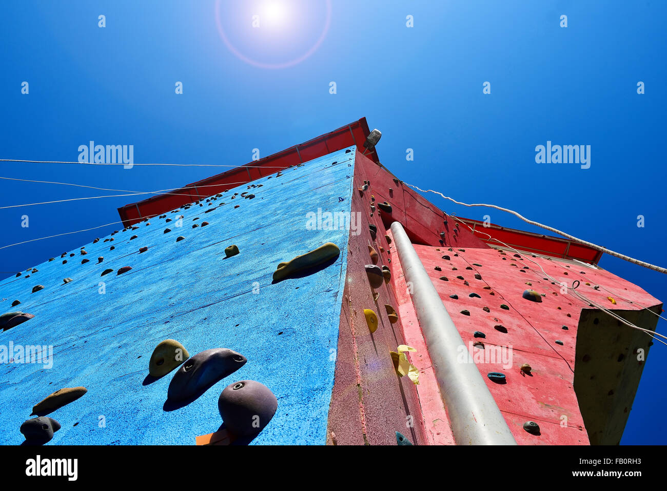 climbing wall for practicing with rope ans blue sky Stock Photo - Alamy