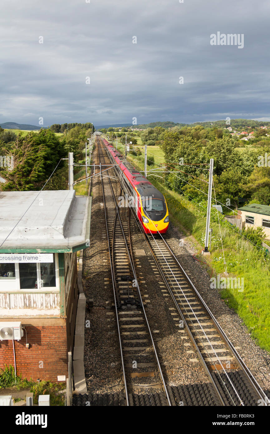 Virgin Trains Pendolino heading south on the straight section of the West Coast Main Line railway at Hest Bank, Lancashire. Stock Photo