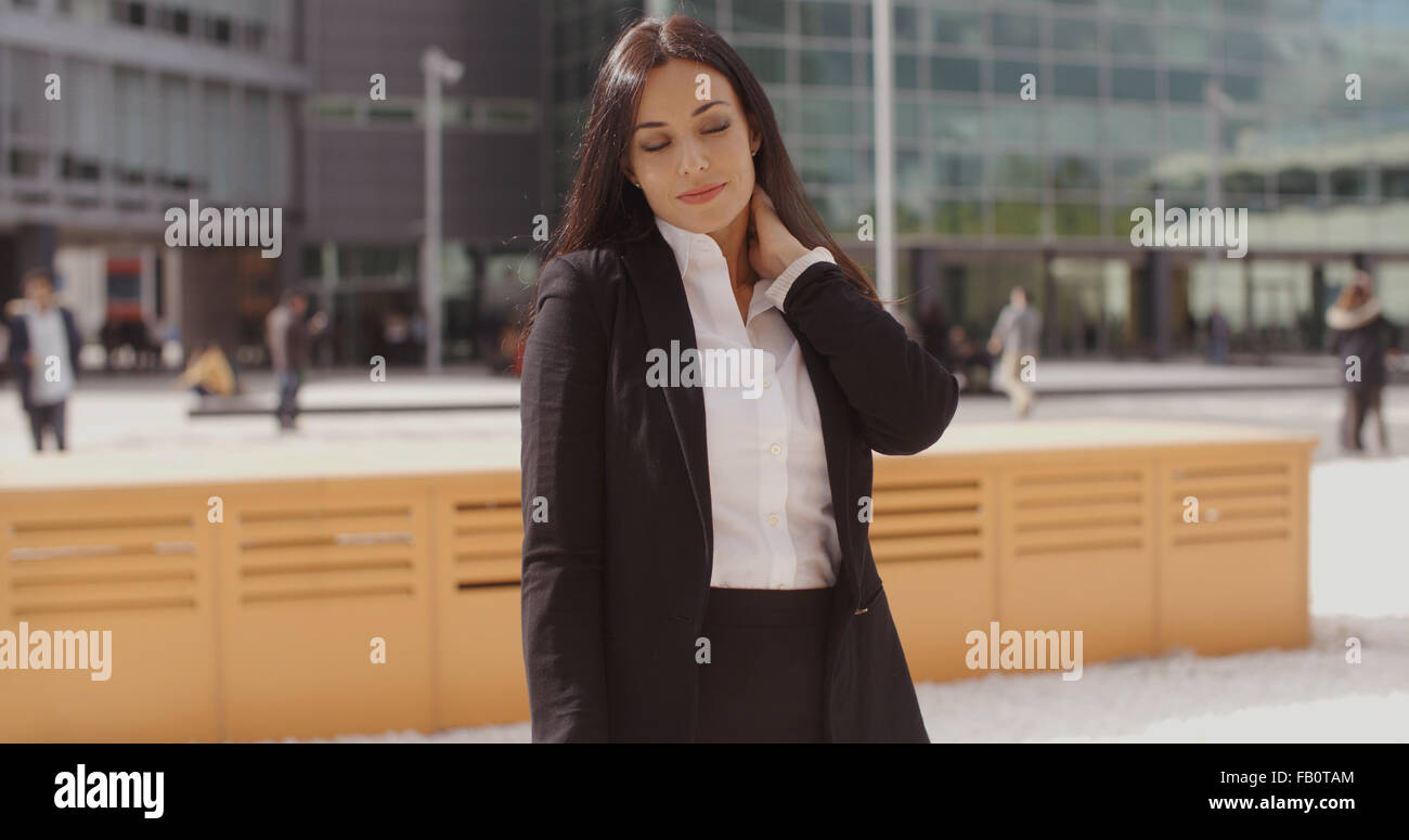 Smart young businesswoman rubbing her neck Stock Photo - Alamy