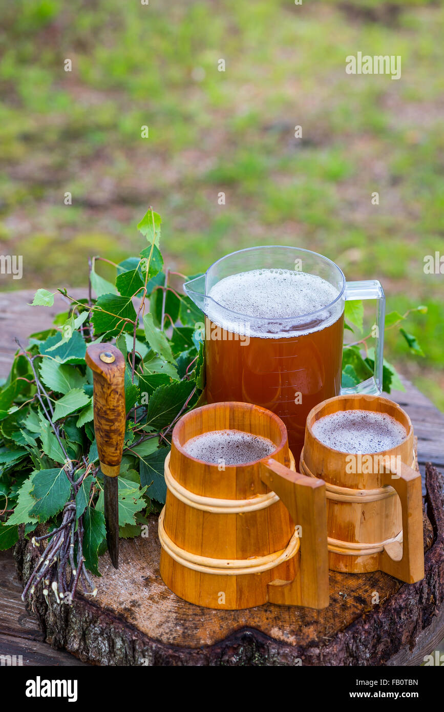 Finnish home brewed malt beer and birch whisk for sauna use Stock Photo