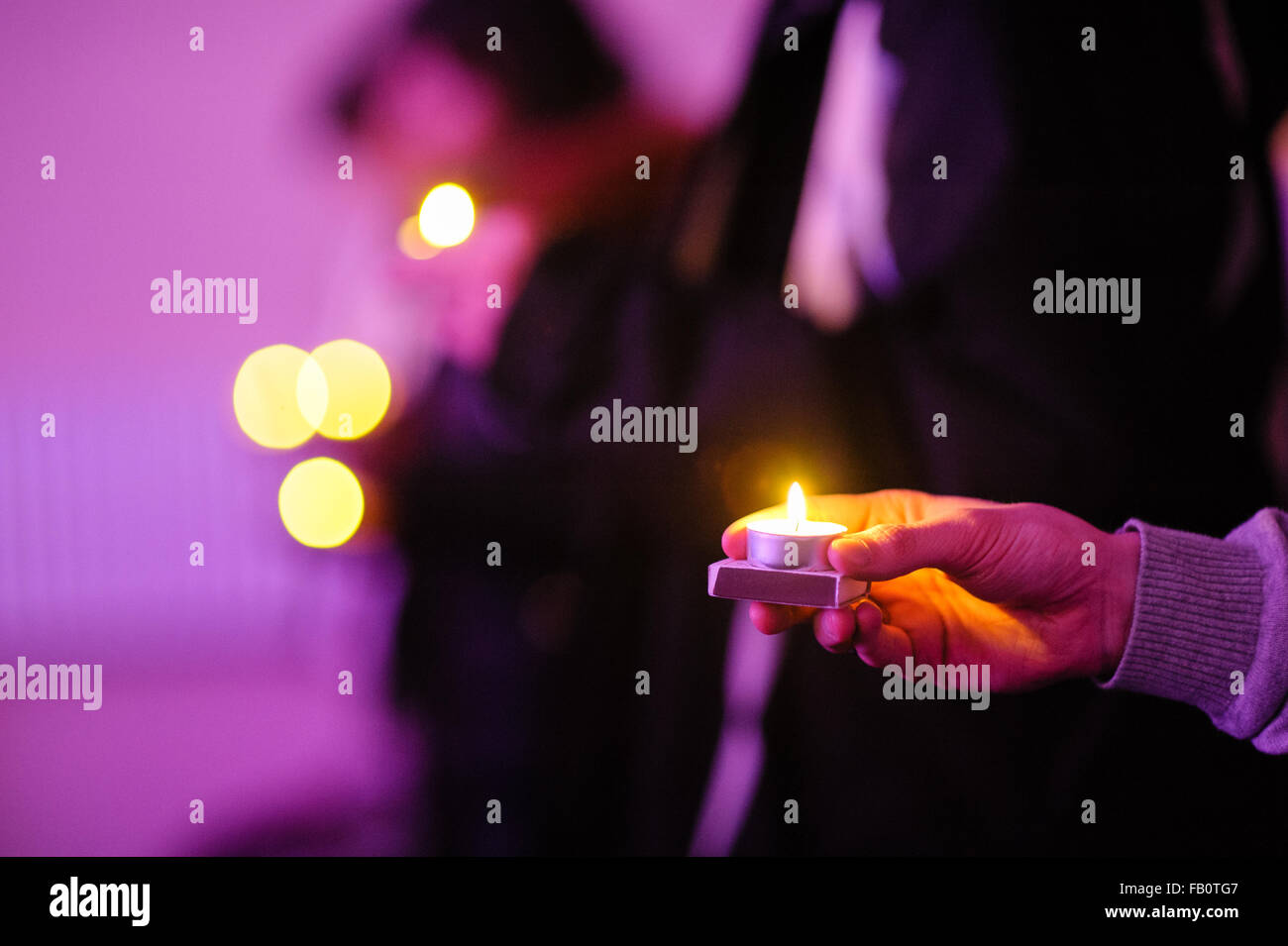 Hand holding candle light. Symbol of hope, peace and love Stock Photo