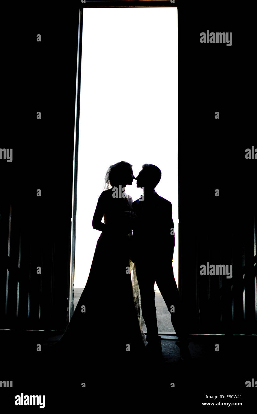 Bride and groom kissing silhouette on their wedding Stock Photo