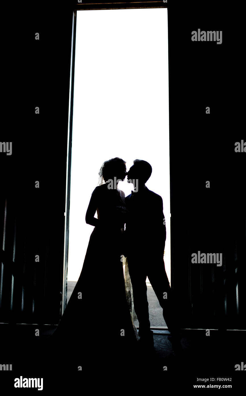 Bride and groom kissing silhouette on their wedding Stock Photo
