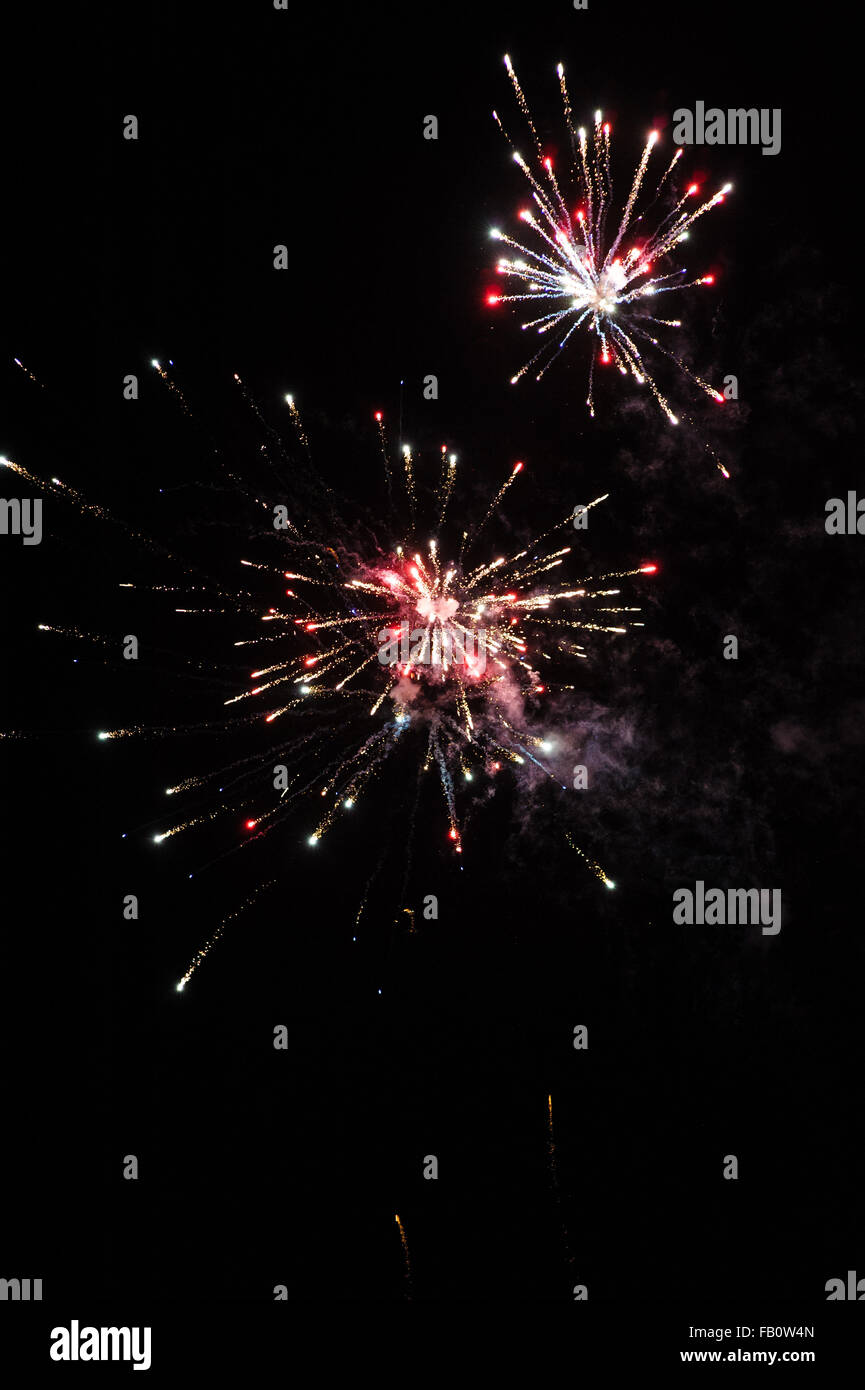 Cluster of colourful fireworks against dark sky Stock Photo