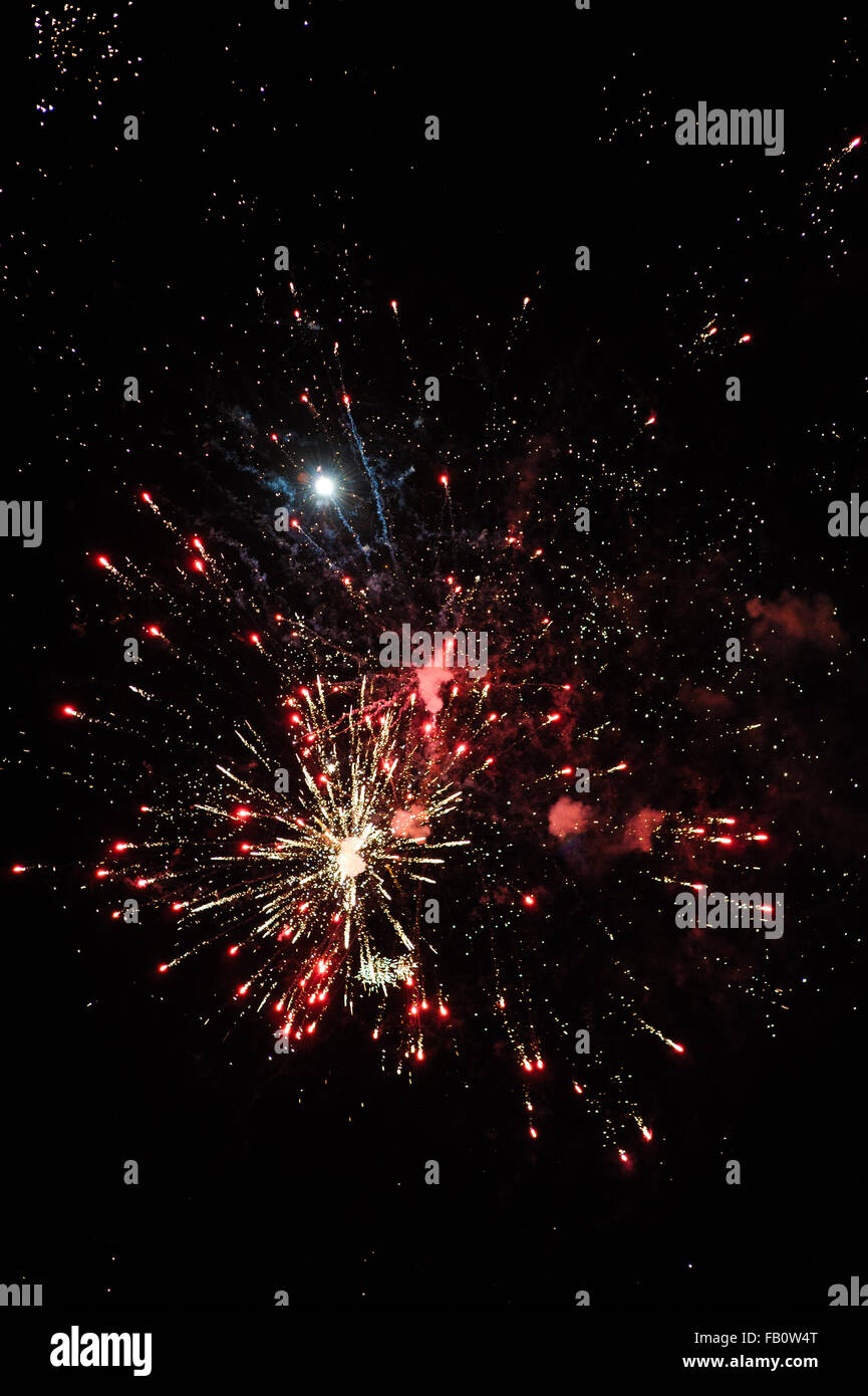 Cluster of colourful fireworks against dark sky Stock Photo